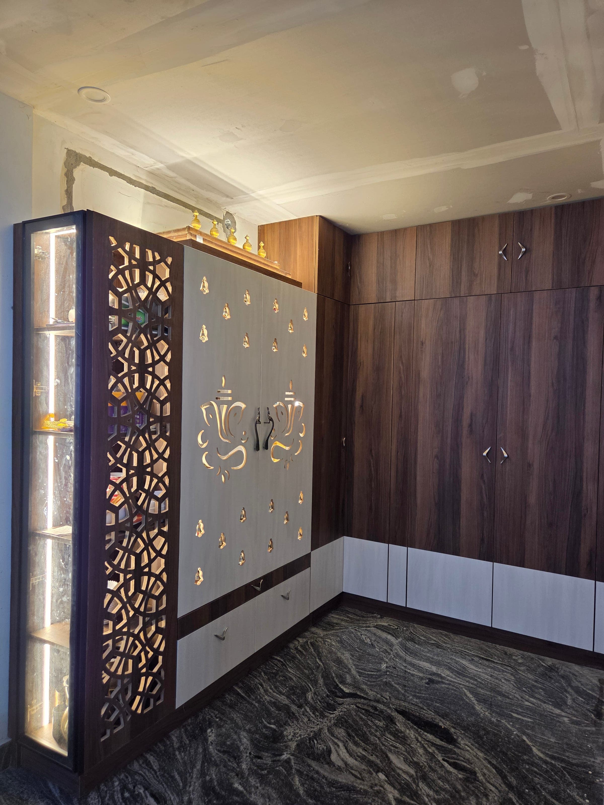 Hand-detailed laser-cut pooja unit shutter in brass-inlay laminate
